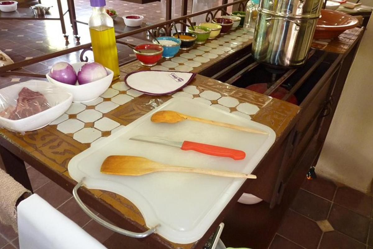 a kitchen counter with two wooden utensils on a cutting board