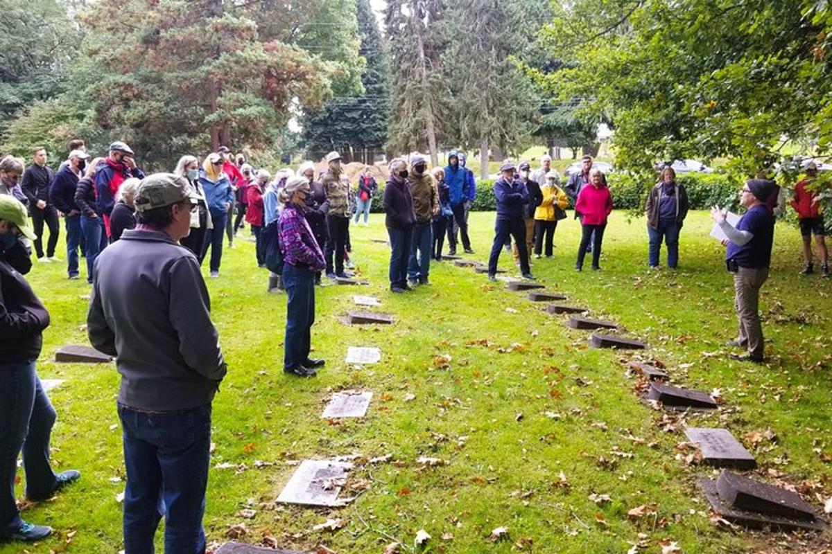 a large group of people standing in the grass