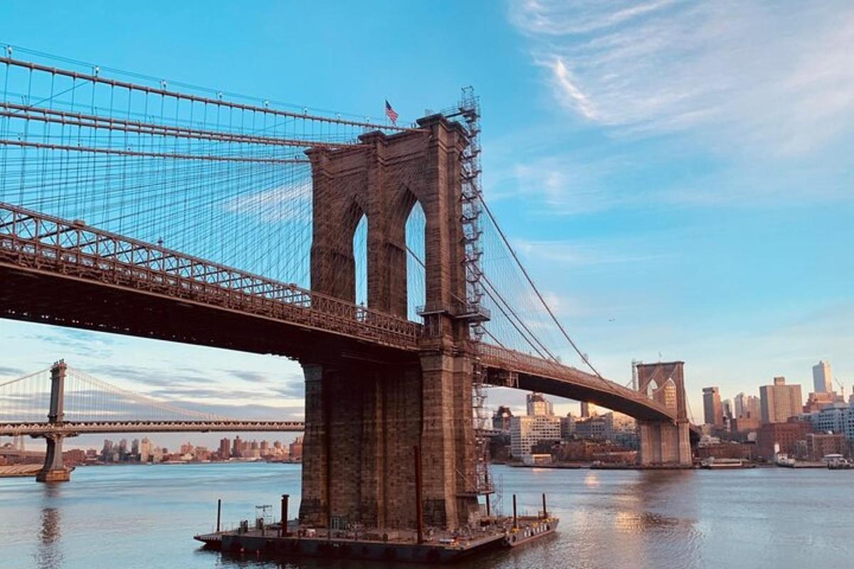 a bridge over the water with a city in the background