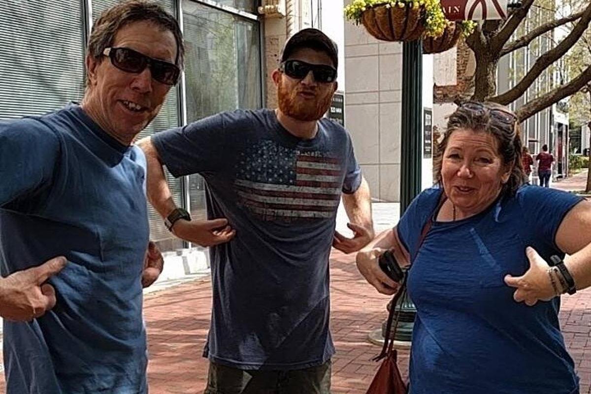 two men and a woman standing next to each other