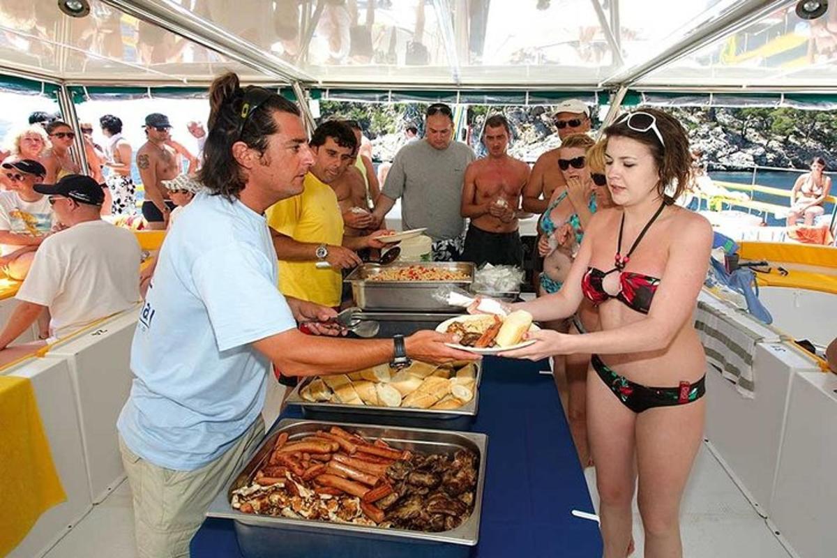 Un hombre le entrega un plato de comida a una mujer en un barco.