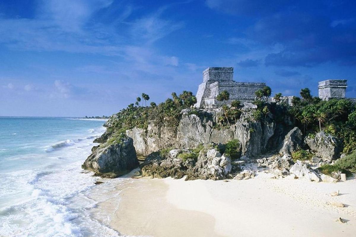uma praia com um castelo no topo de um penhasco