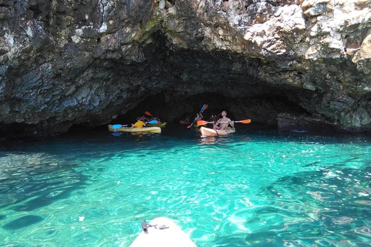 a group of people in a cave in the water