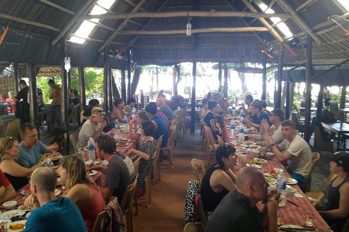 a group of people sitting at tables in a restaurant