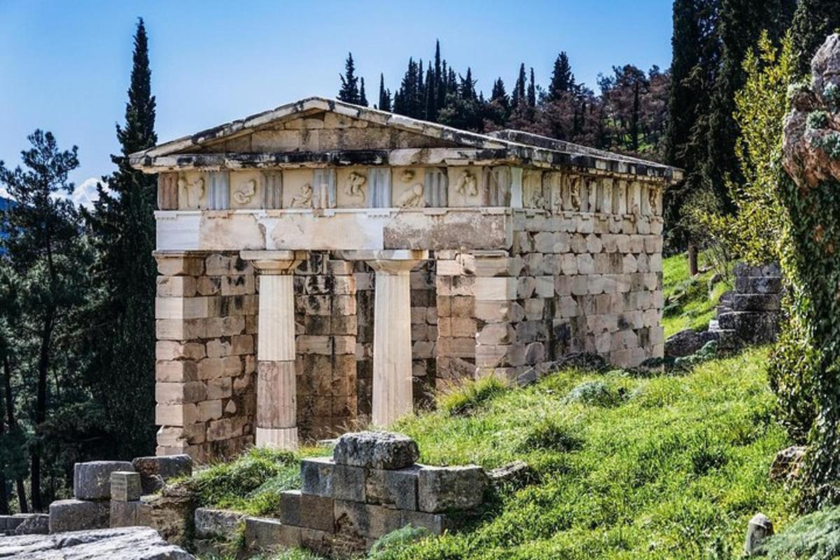an ancient building on a hill with grass and trees