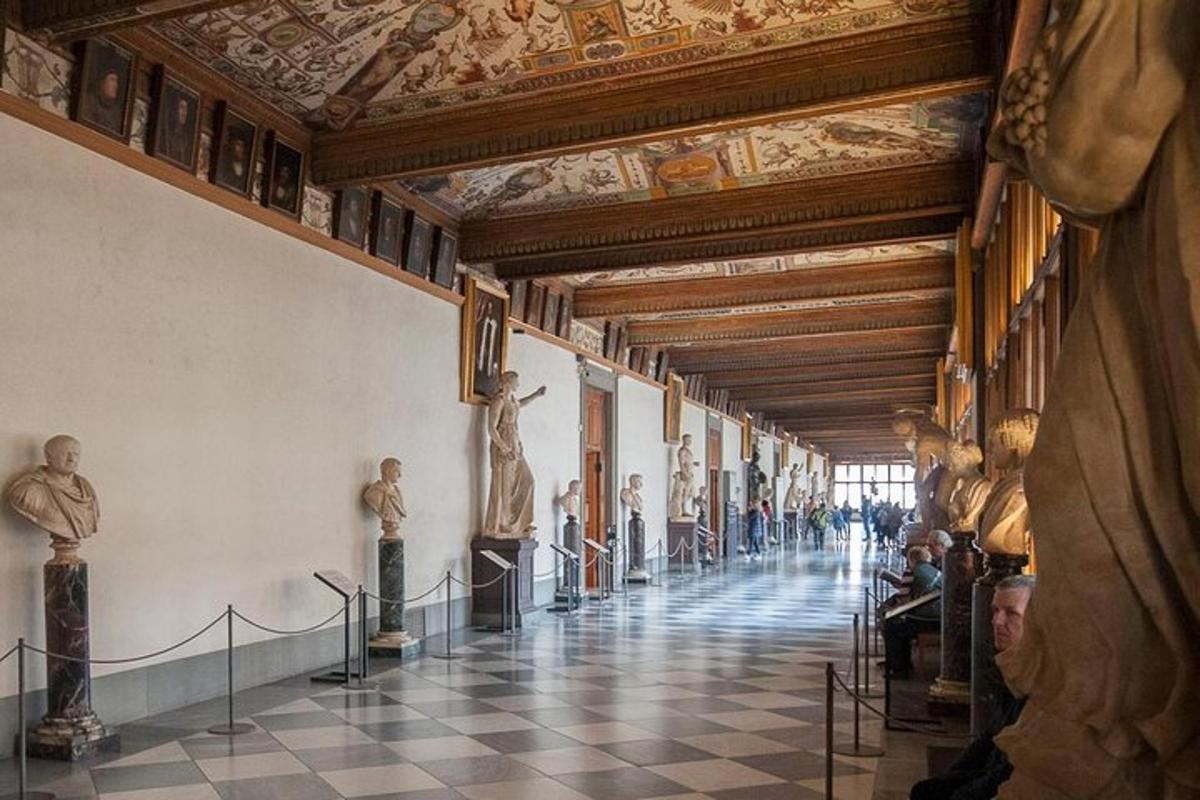 a hallway in a museum with statues on the walls