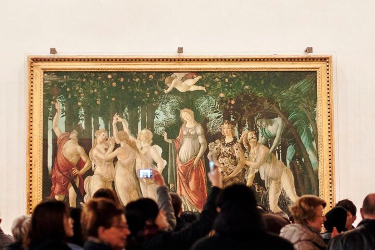 a crowd of people standing in front of a painting