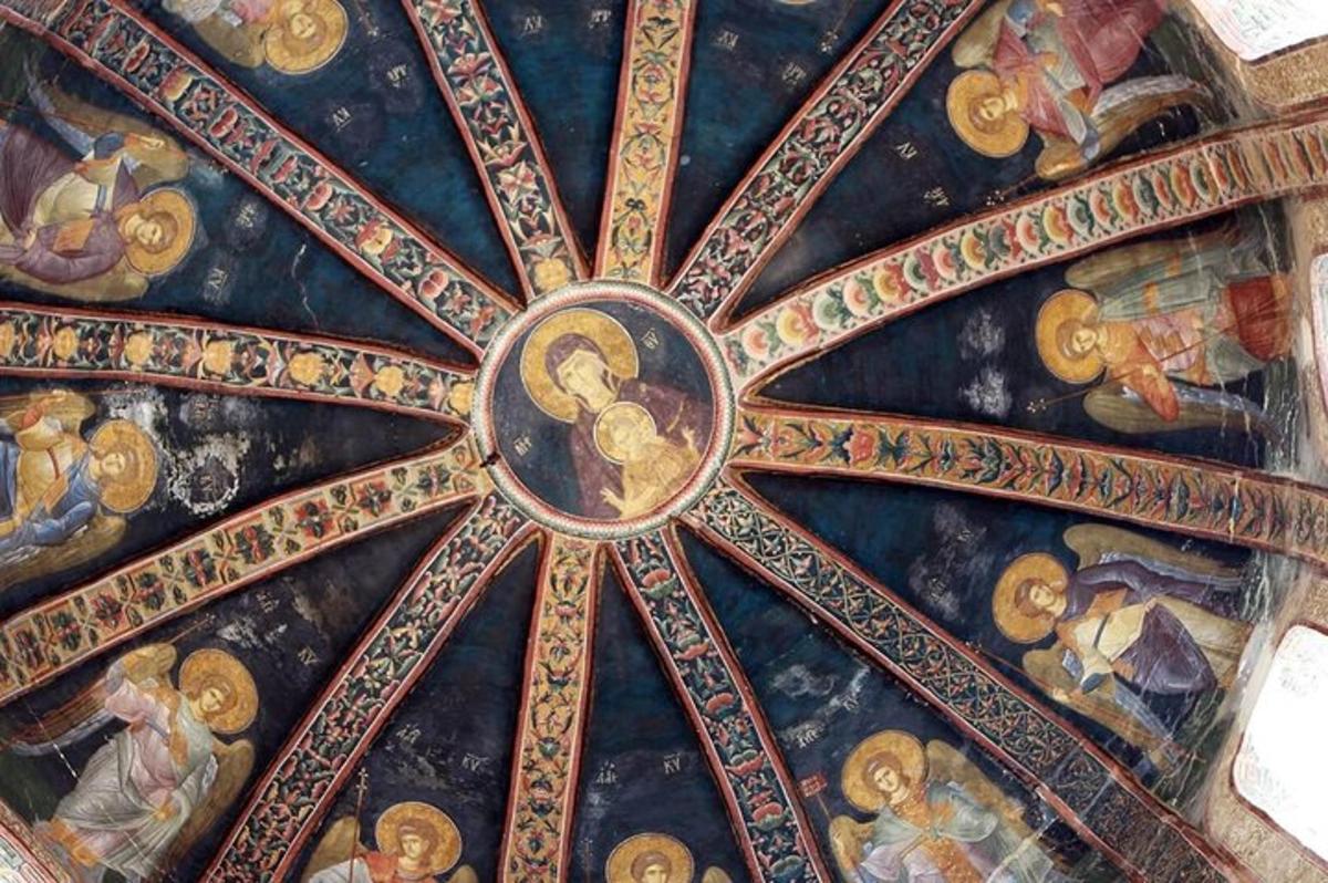 a ceiling of a church with paintings on it