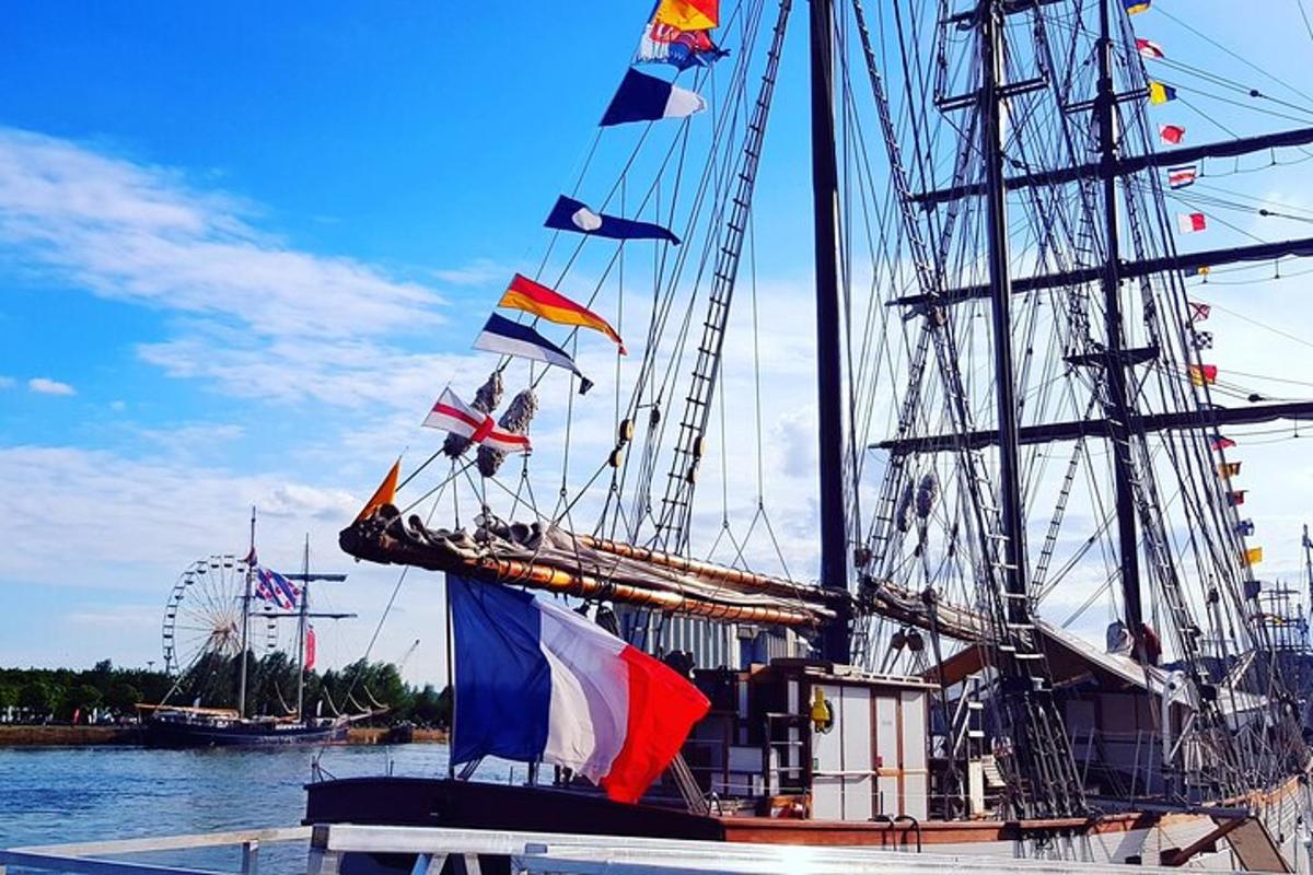 a boat with flags on it sitting in the water