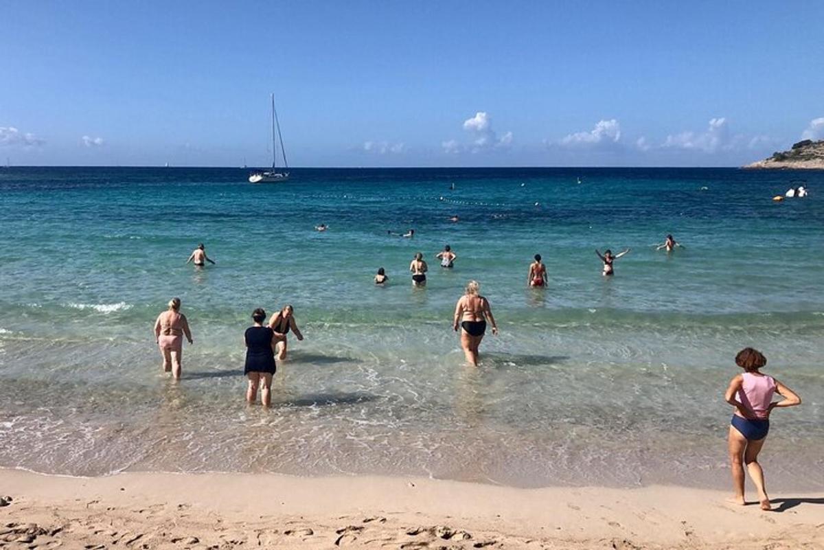 a group of people in the water at the beach