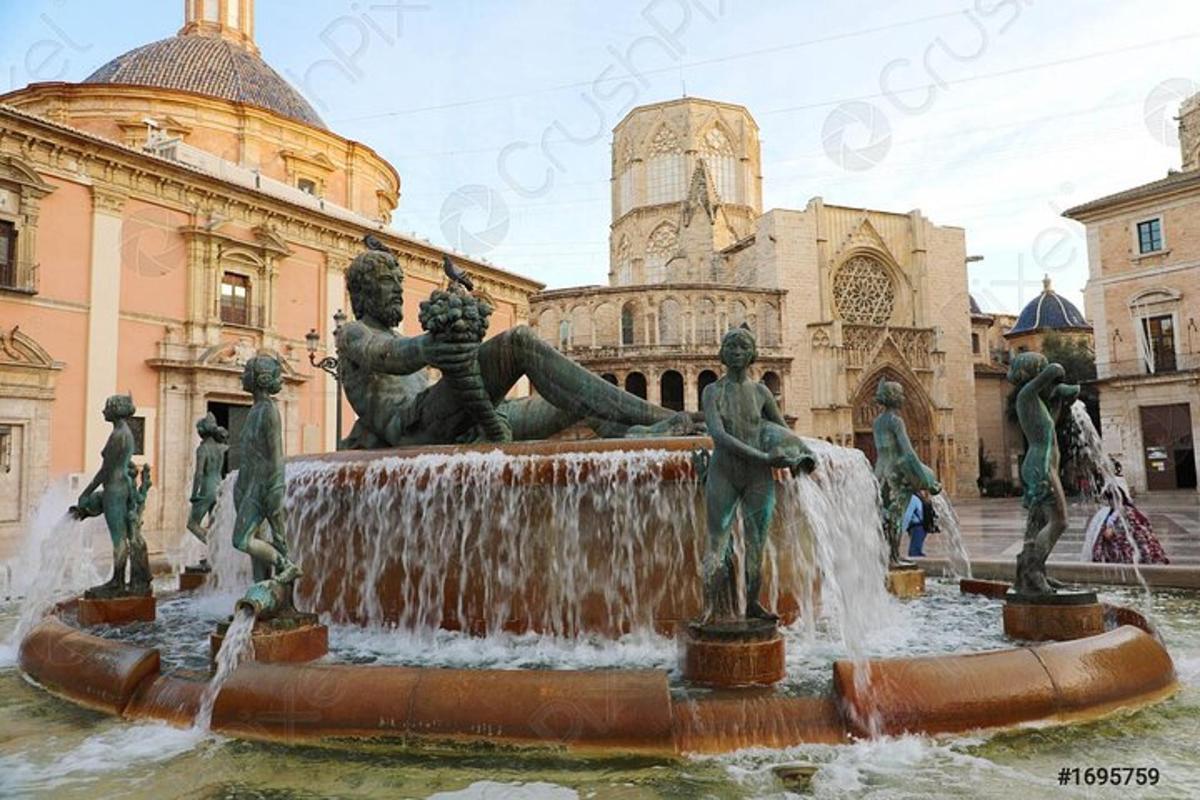 a fountain with statues in front of a building