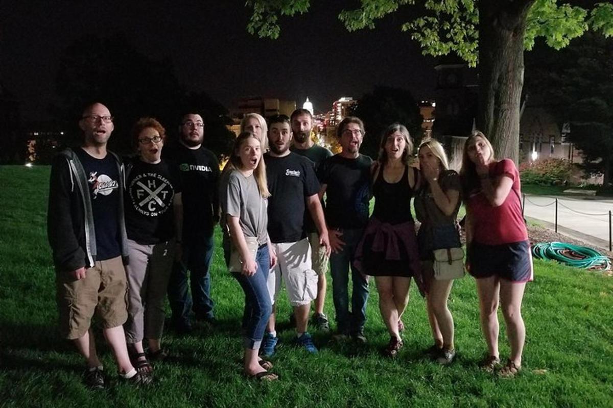 a group of people standing in the grass at night