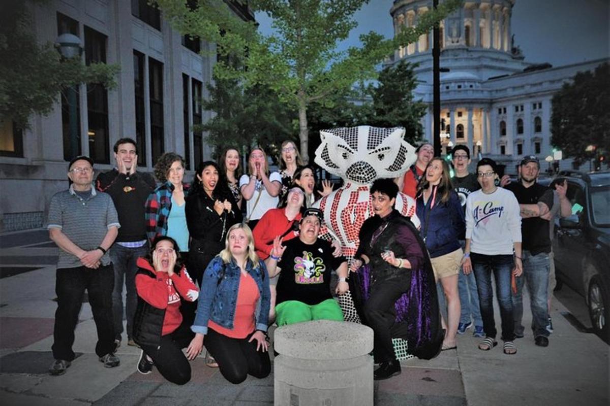 a group of people posing for a picture on a sidewalk