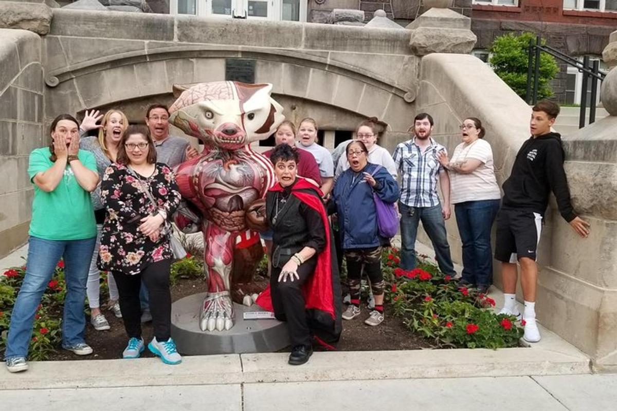 a group of people standing in front of a statue