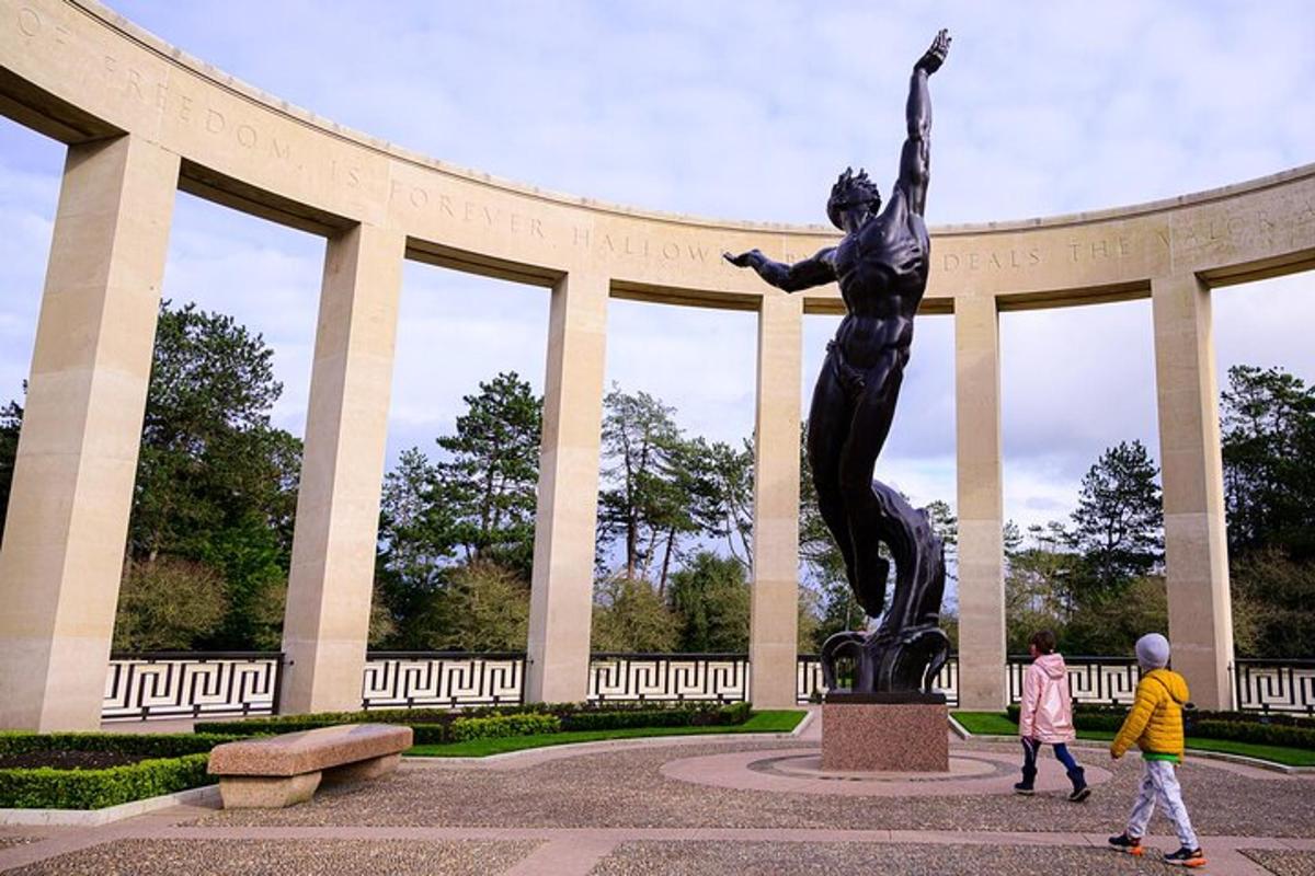 two children walking past a statue in front of a building