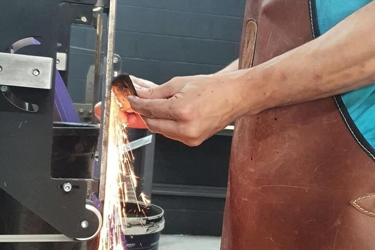 a person holding a piece of food in a machine