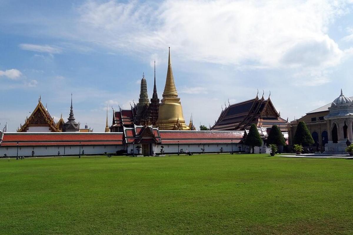 a building with a green field in front