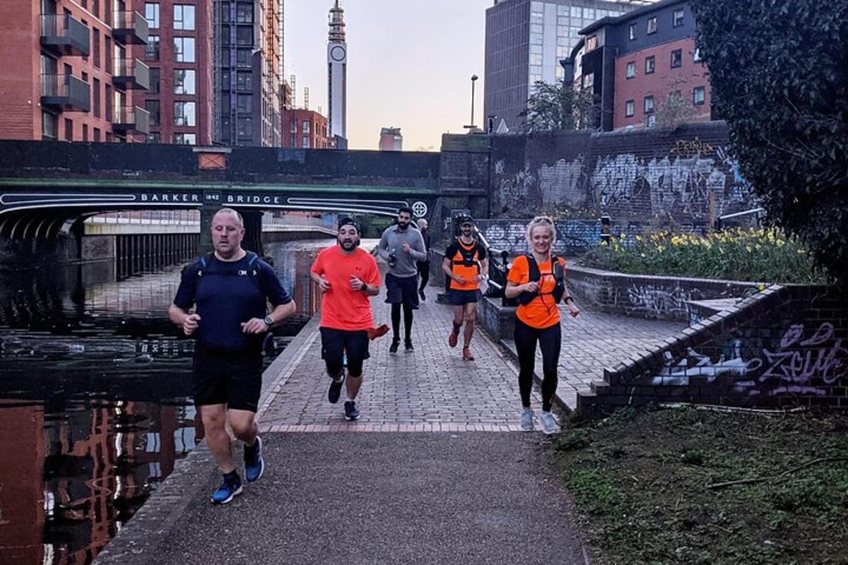 a group of people running down a path in a city