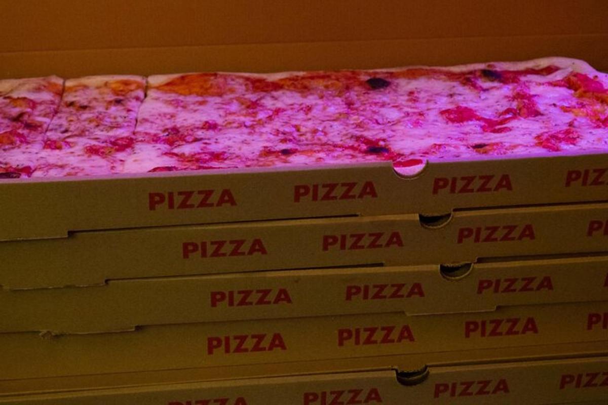 una pila de caixes de pizza amb una pizza