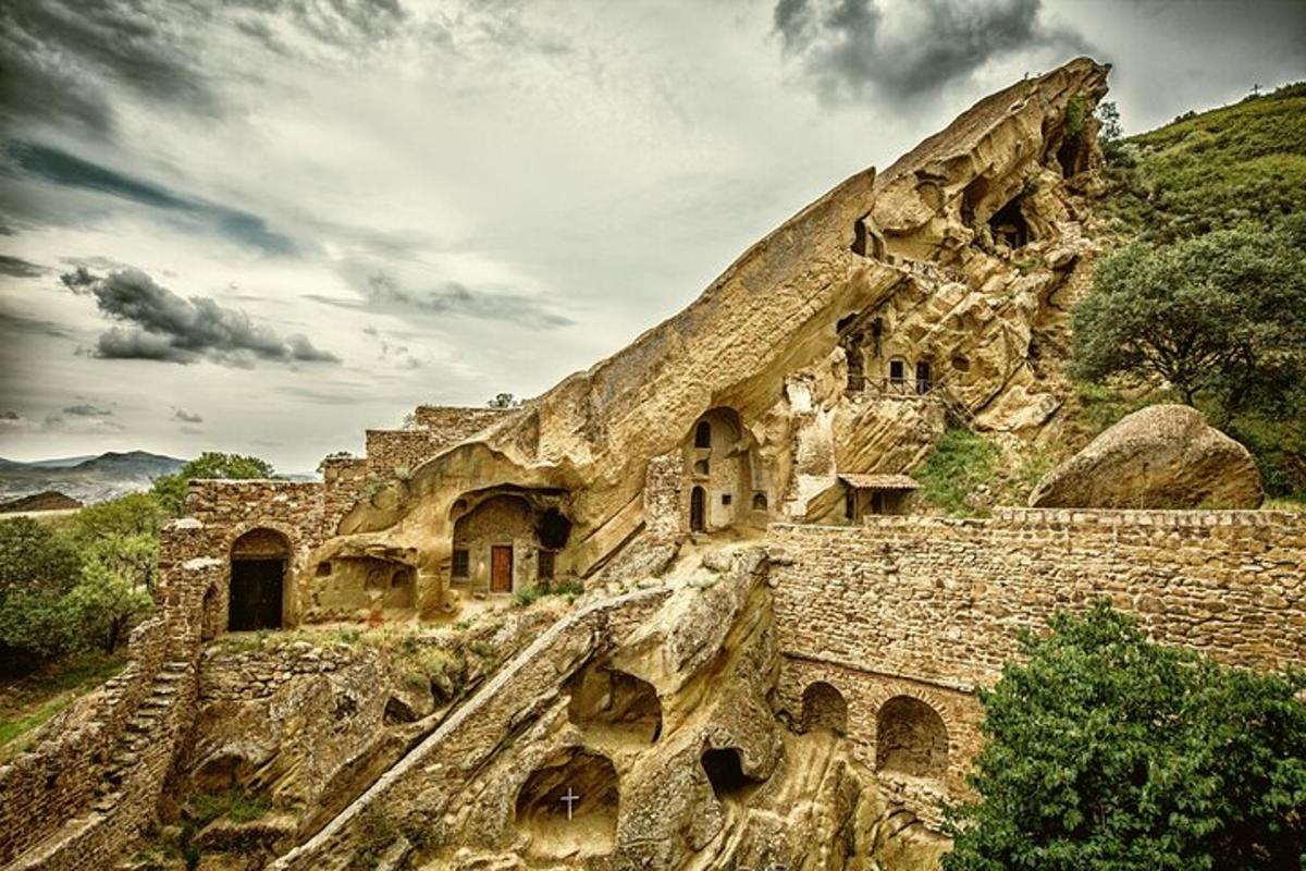 un vecchio edificio in pietra su una collina con un cielo