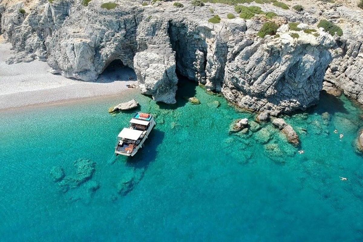 a boat in the water next to a beach