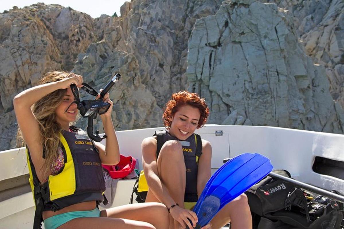 two women in life jackets on a boat