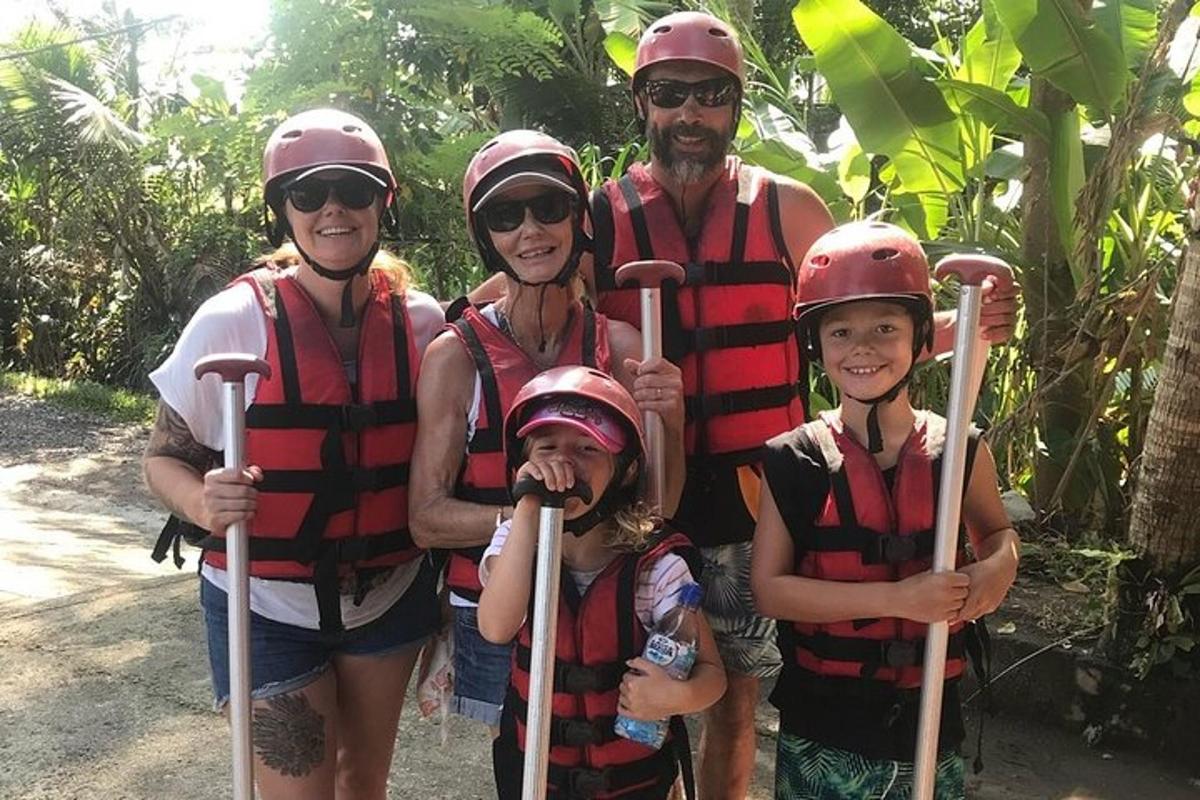 a group of people wearing helmets and holding paddles