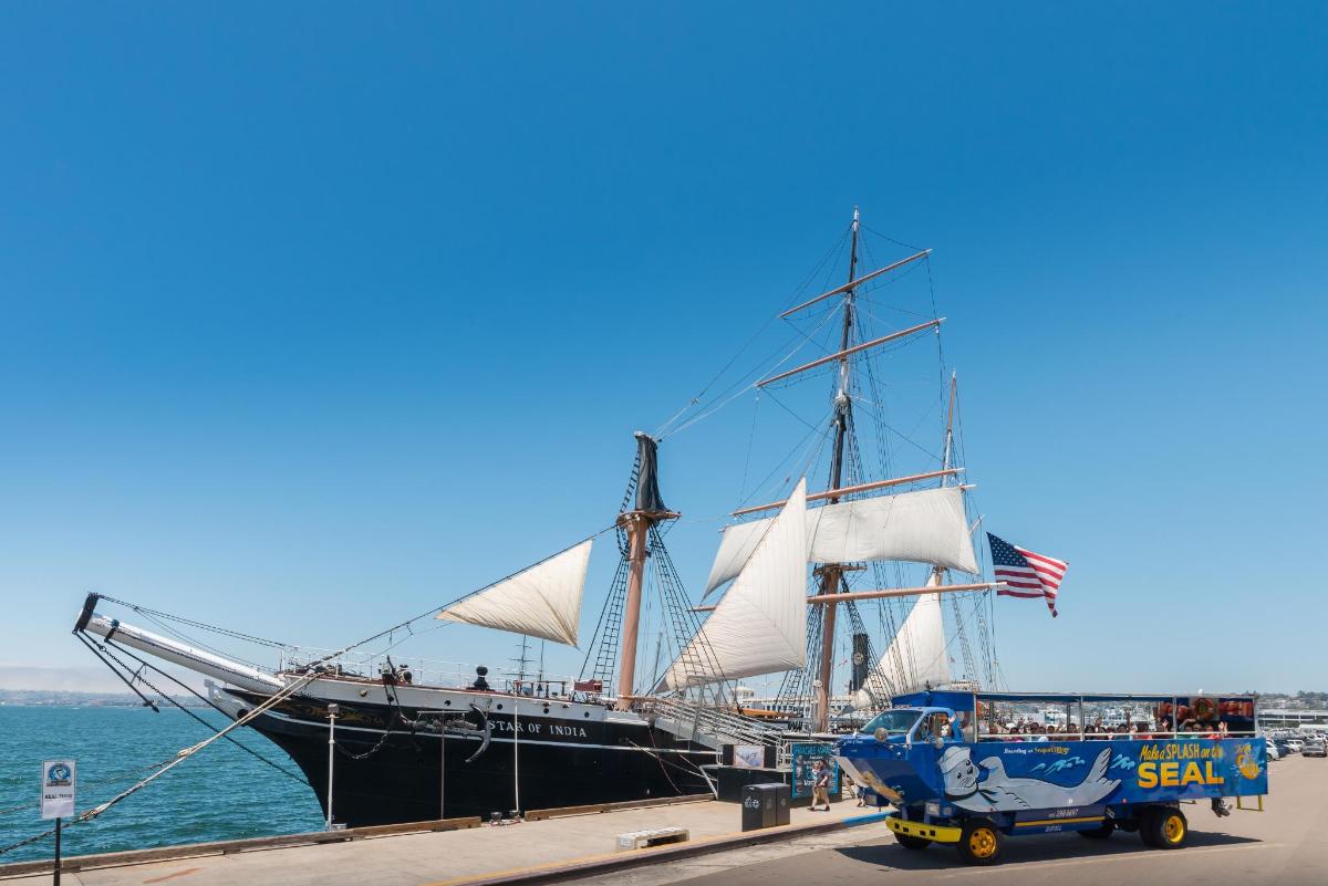 a tall ship parked next to the water