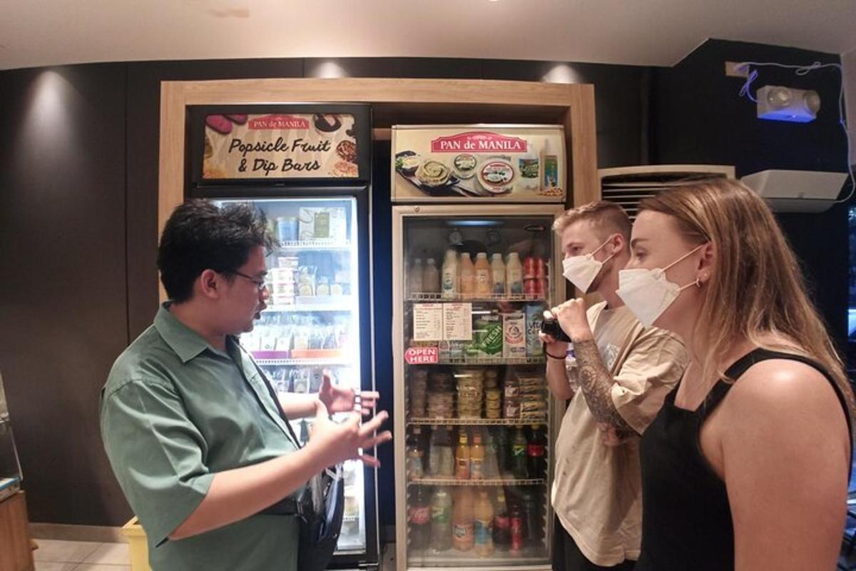 two people wearing face masks standing in front of a refrigerator