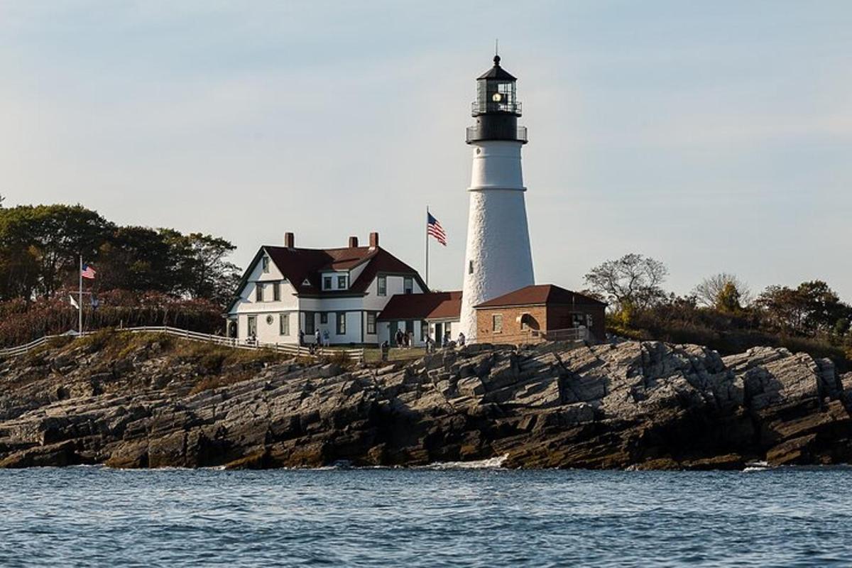 a lighthouse sitting on top of a rocky island