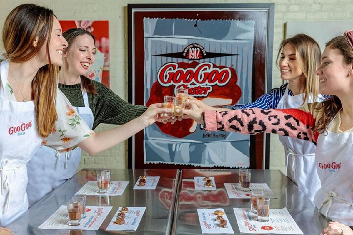 a group of women standing around a table with drinks