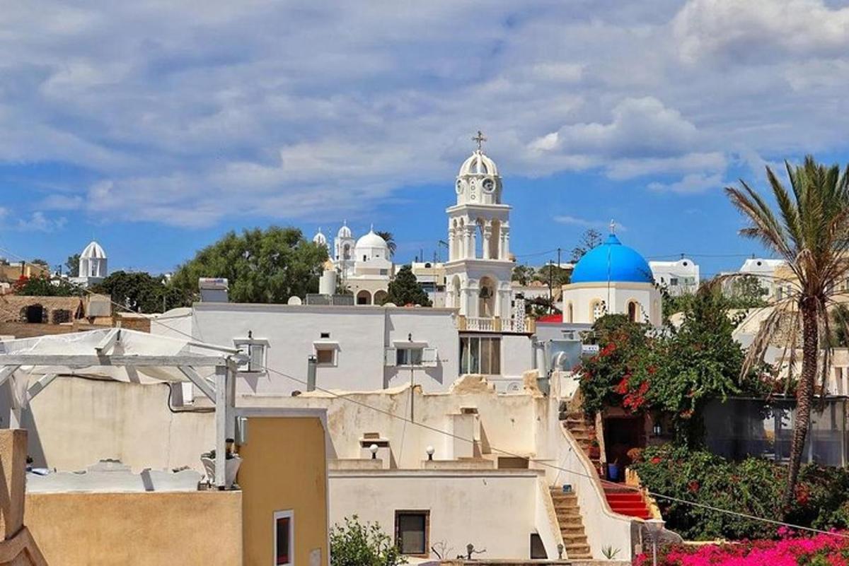a white building with a church in the background