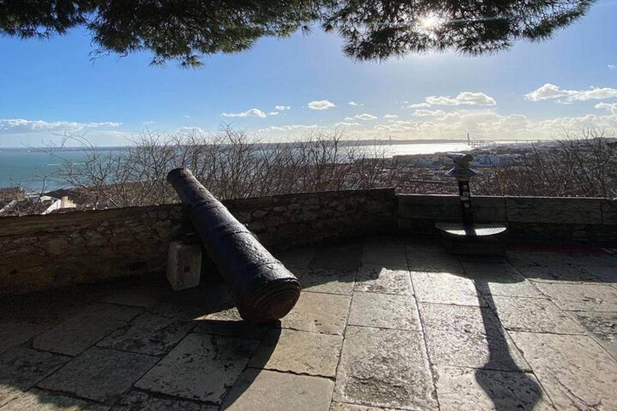 a cannon sitting on a wall near the ocean