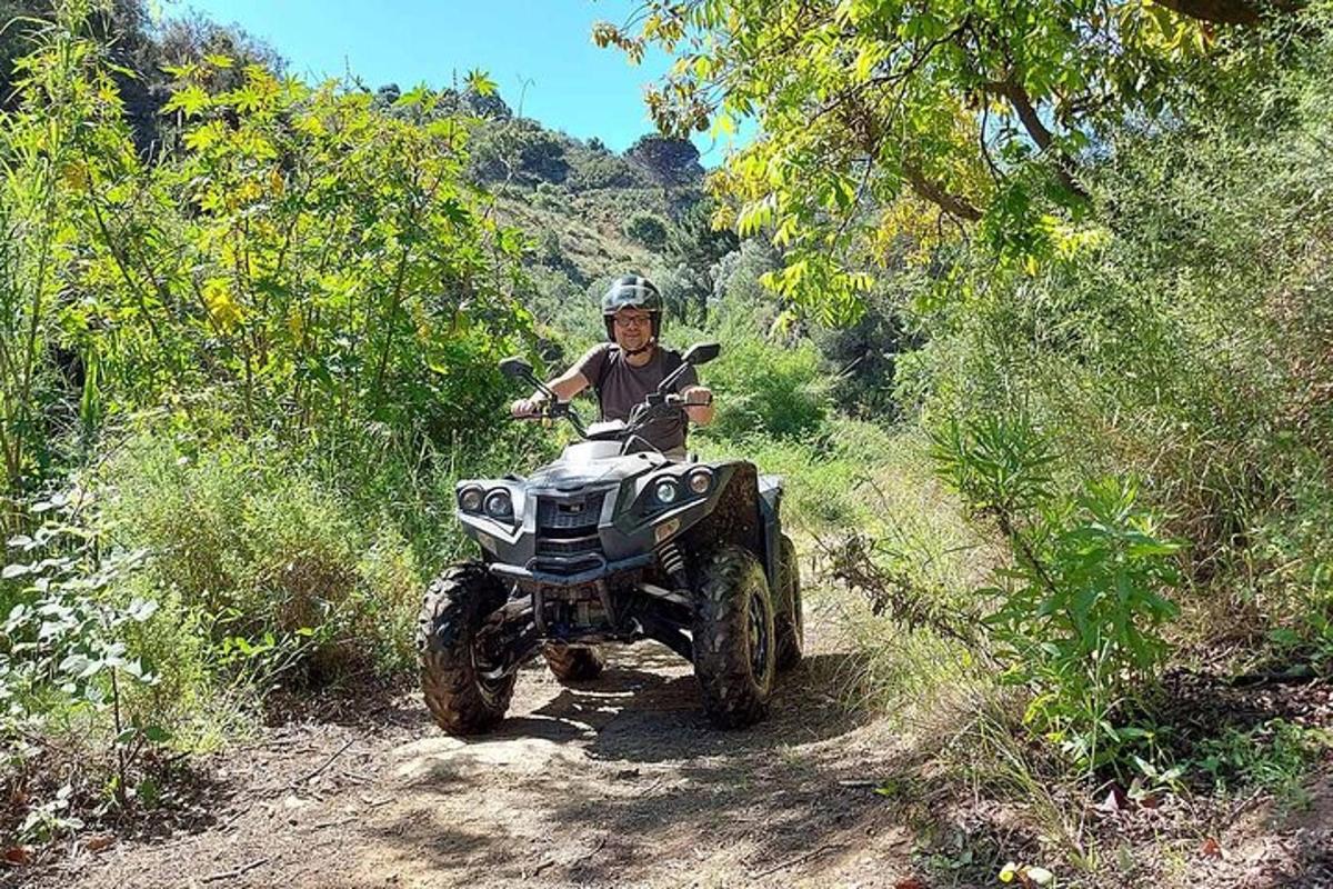 a person riding a quad bike on a dirt road