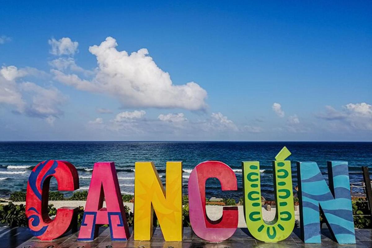 a sign for the beach with the ocean in the background