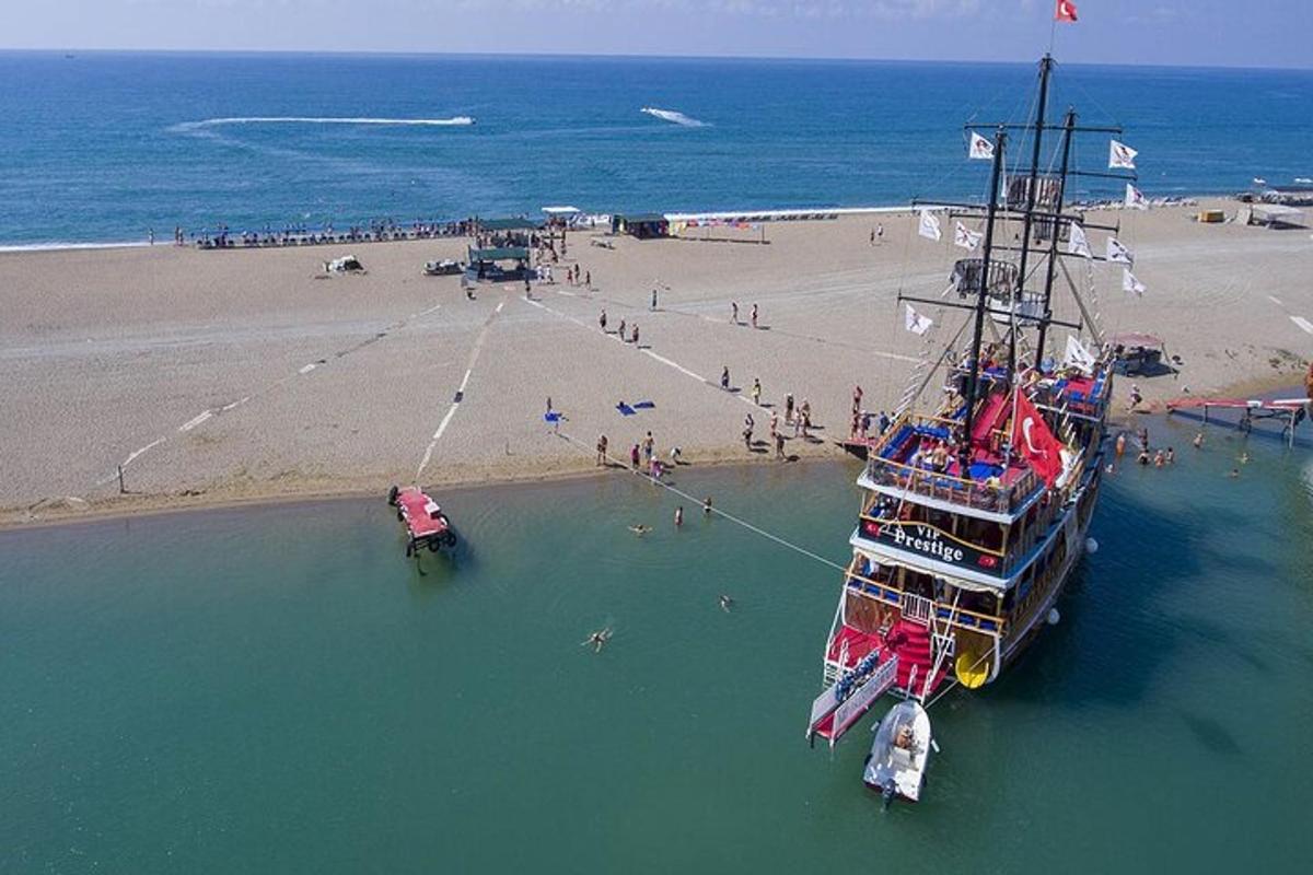 a boat in the water next to a beach