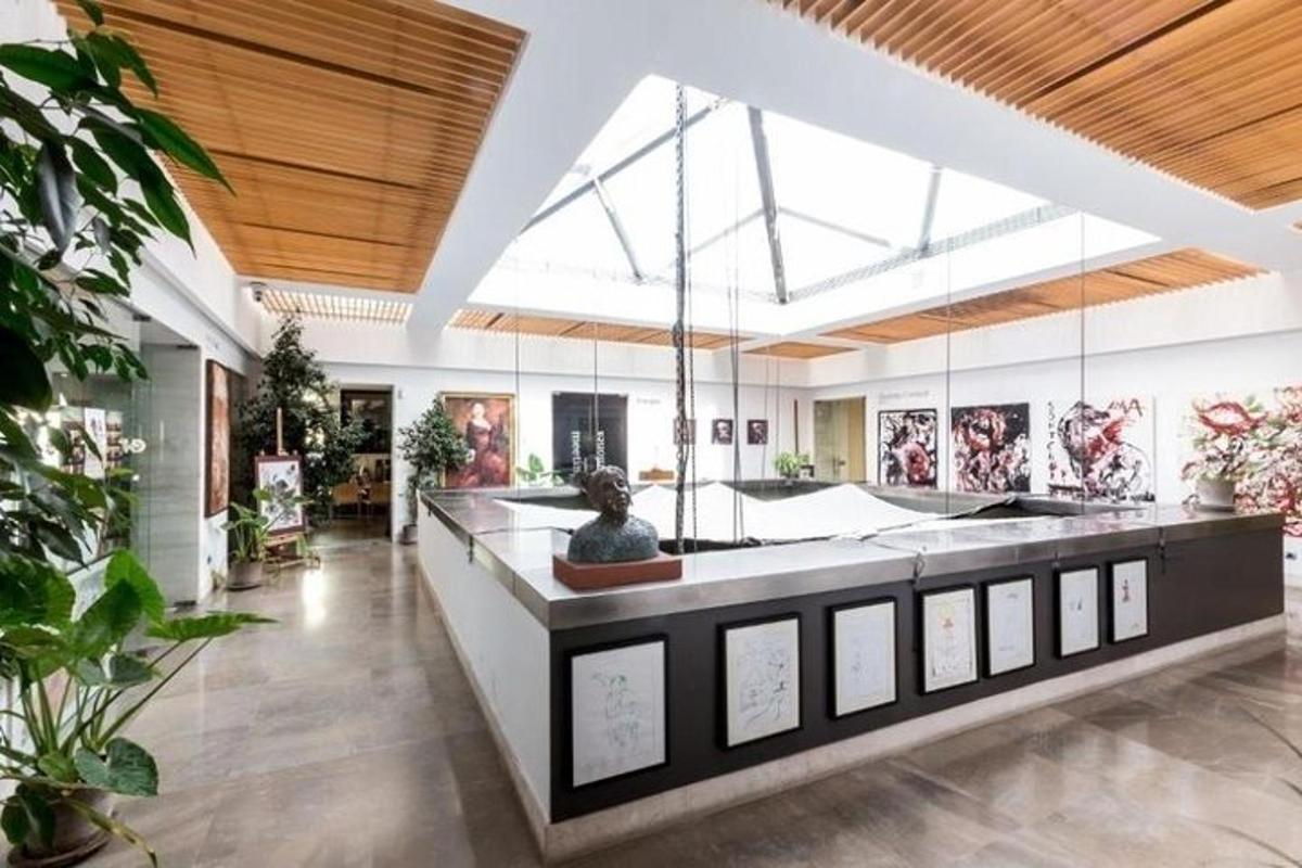 a large room with paintings on the walls