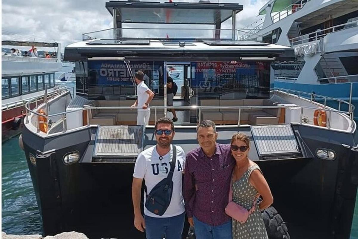 a group of people standing in front of a boat