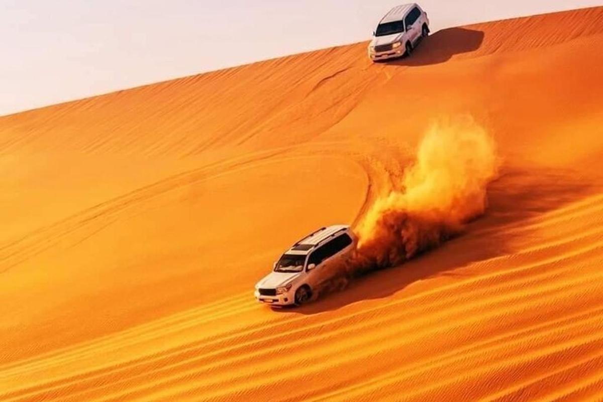 two cars on the sand in the desert