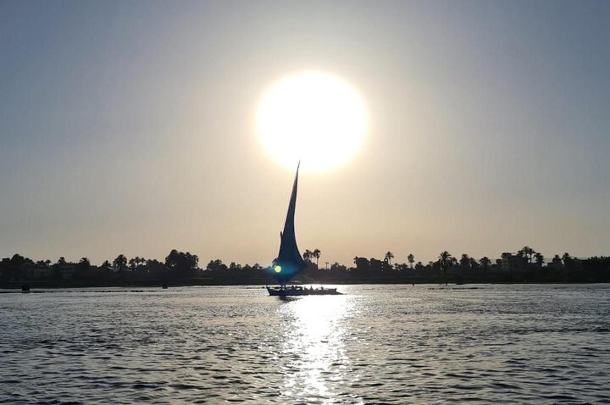 a boat on the water with the sun in the sky