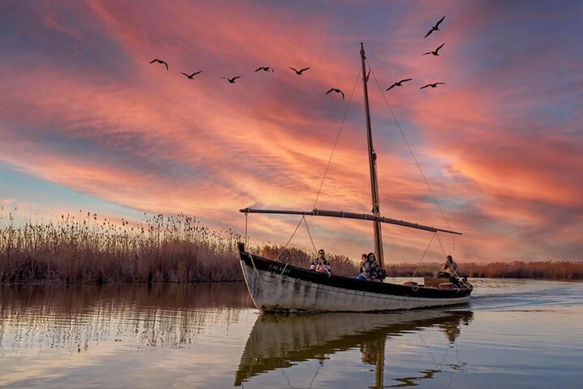 a group of people on a boat in the water with birds