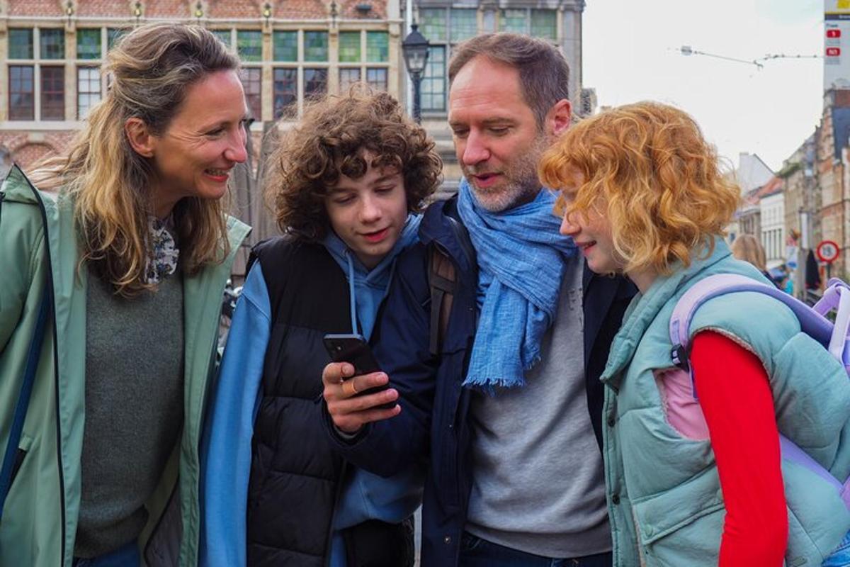 skupina lidí dívajících se na mobilní telefon
