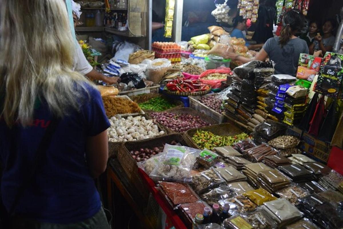a group of people standing in a market with produce
