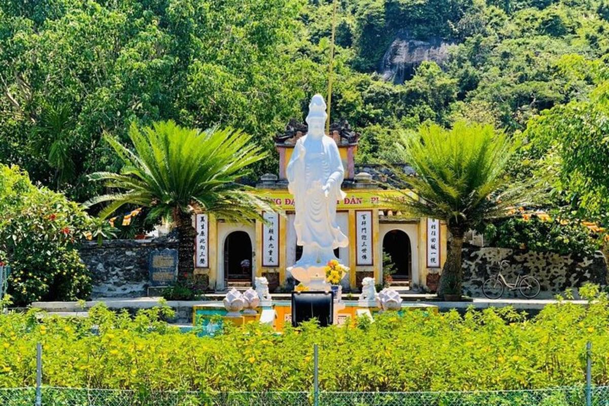 a large white statue in front of a building