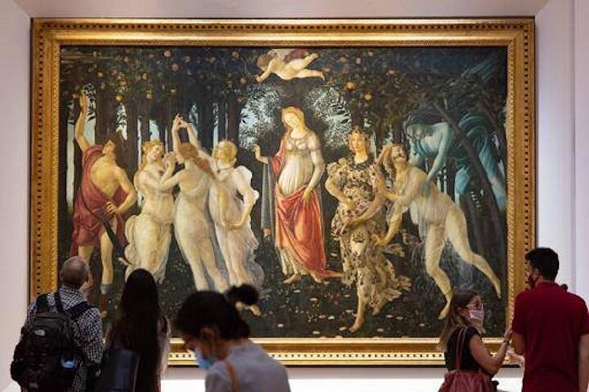 people standing in front of a painting in a museum