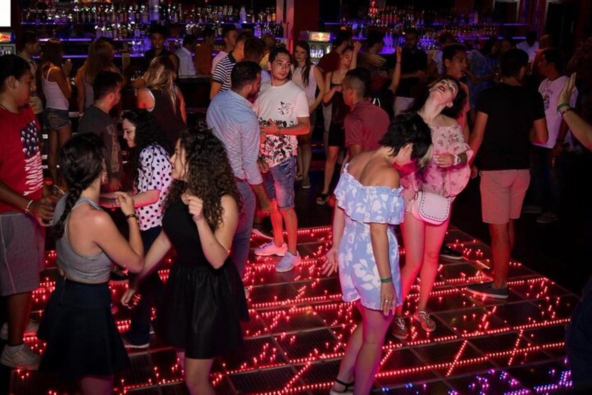 a group of people dancing in a nightclub