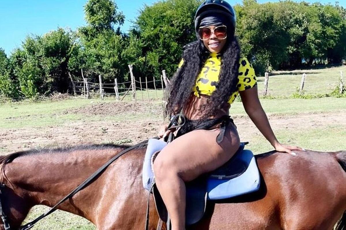 a woman sitting on top of a horse