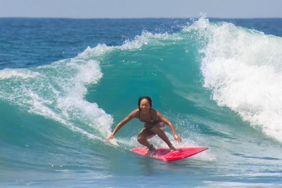 a woman riding a wave on a surfboard in the ocean
