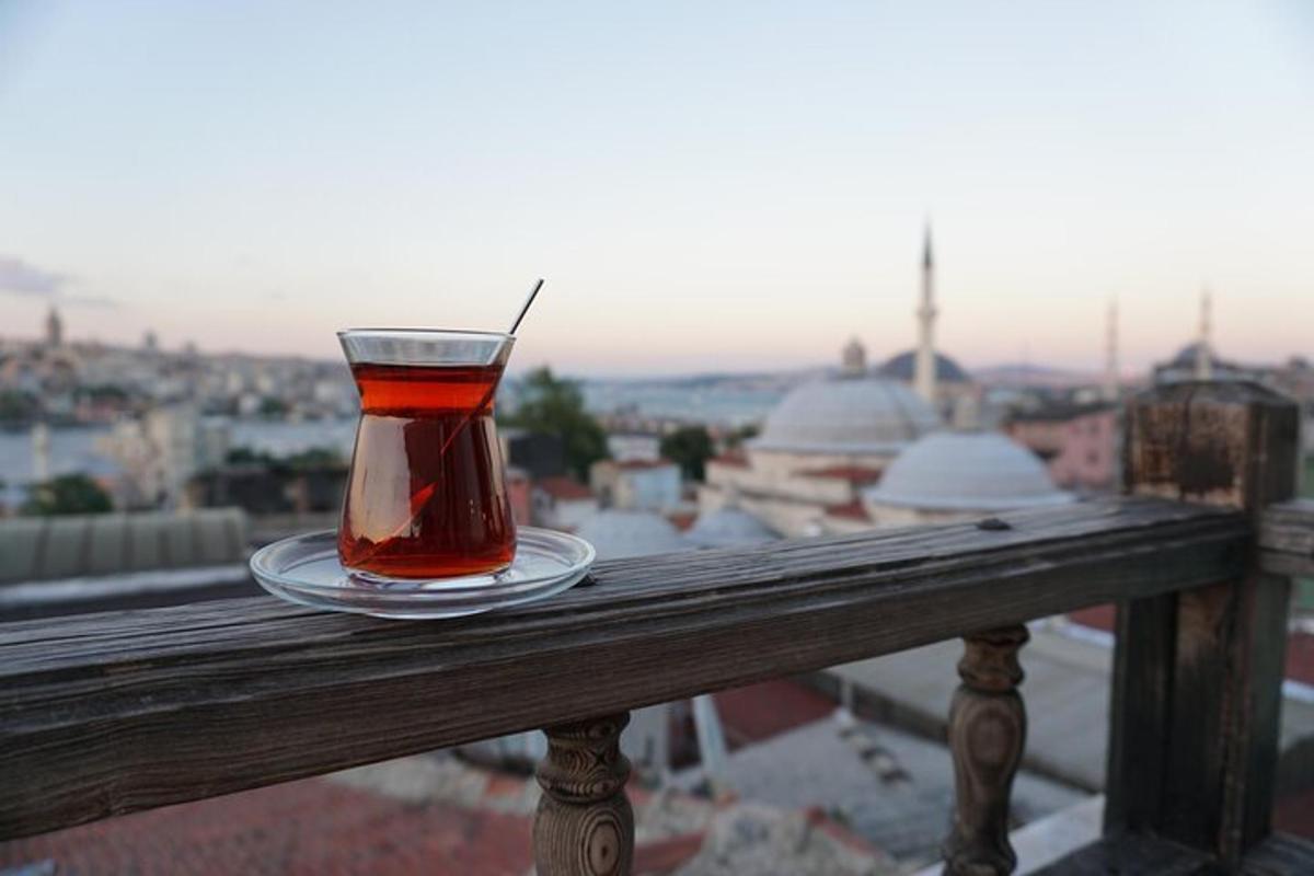 a cup of tea sitting on a rail on a balcony