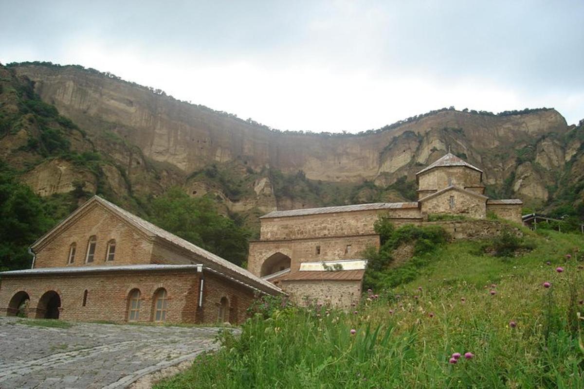 a church on a hill with a mountain in the background